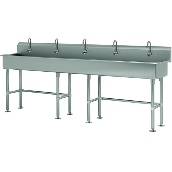A large stainless steel multi-station hand sink with 5 faucets.