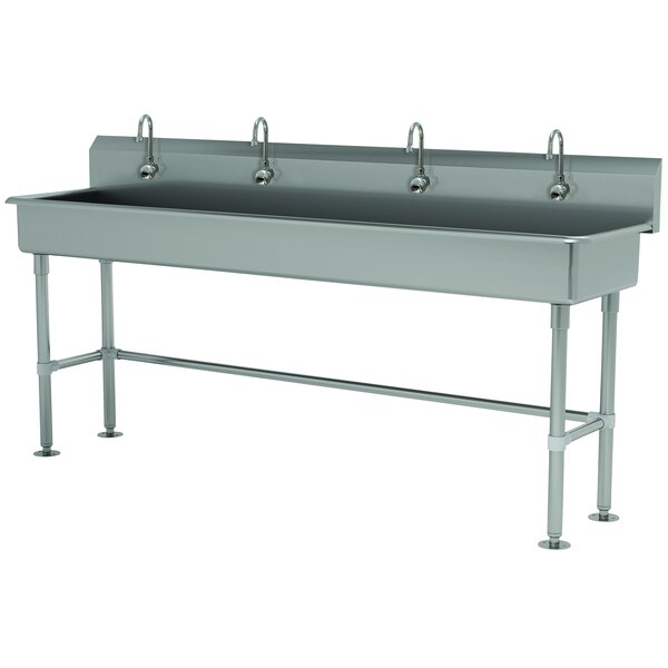 A large rectangular Advance Tabco stainless steel utility sink with 4 electronic faucets.