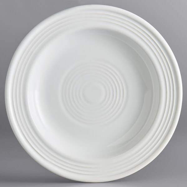 An Acopa Capri coconut white stoneware plate with a spiral pattern on it.