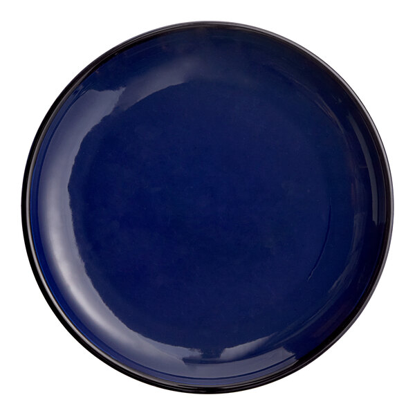 A round, deep blue porcelain coupe plate.