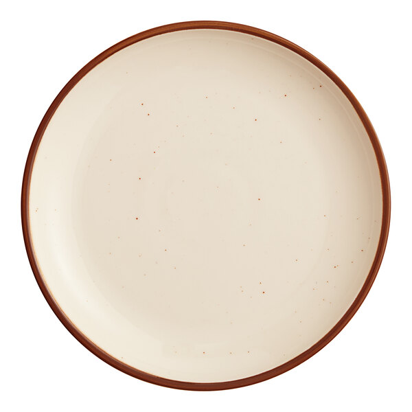 A round porcelain coupe plate with a vanilla bean color and a brown rim.