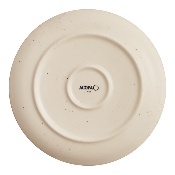 An Acopa Keystone 8 1/2 inch vanilla bean porcelain coupe plate shown from the bottom.