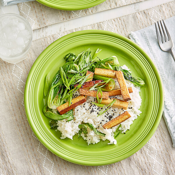 A close up of an Acopa Capri bamboo stoneware plate with rice and vegetables.