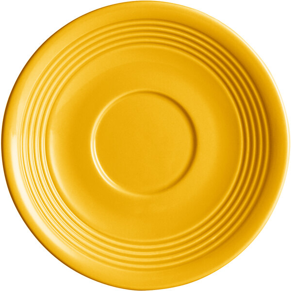 An Acopa Capri mango orange saucer with a circular pattern on the rim.