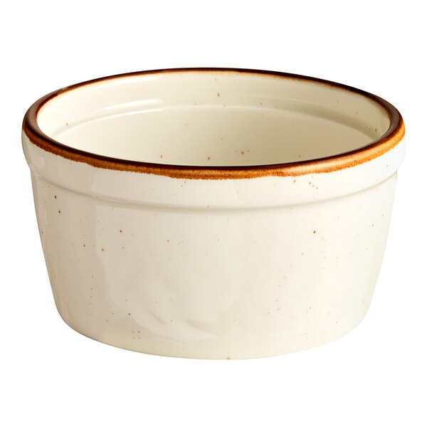 A small, round, vanilla-colored porcelain ramekin with a brown rim.