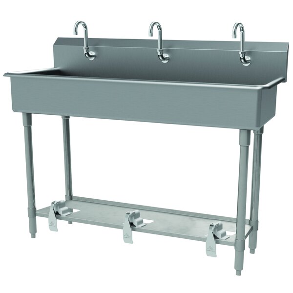 A stainless steel Advance Tabco multi-station hand sink with toe-operated faucets.