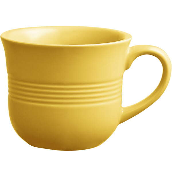 An Acopa Capri citrus yellow coffee cup with a handle.
