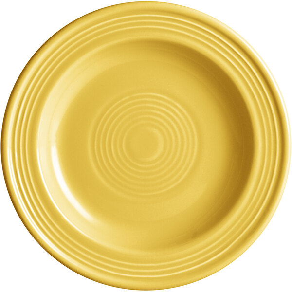 A yellow Acopa Capri stoneware plate with a circular pattern.