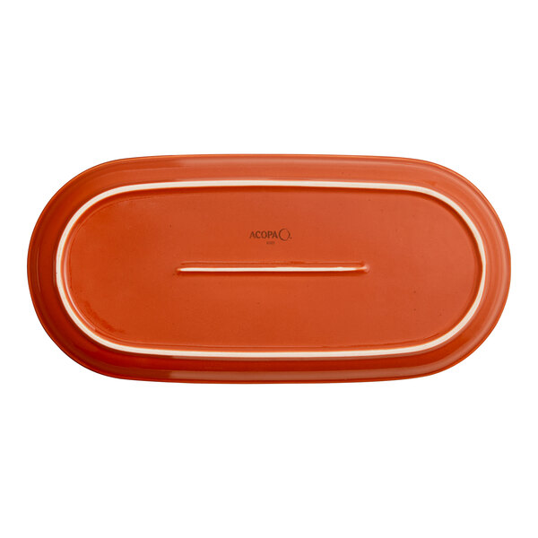 An orange stoneware oblong coupe platter.