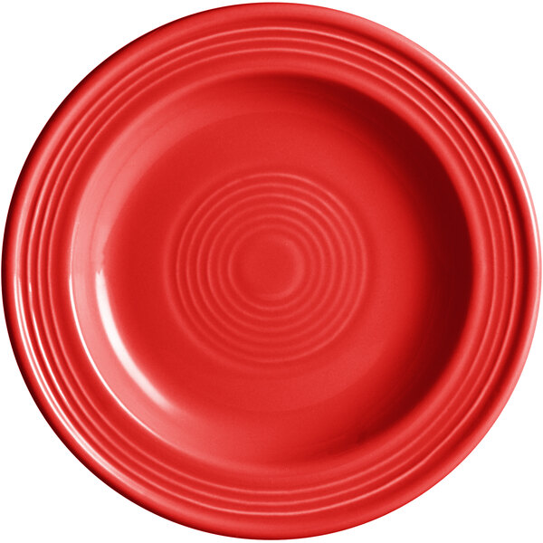 An Acopa Capri passion fruit red stoneware plate with a spiral pattern.
