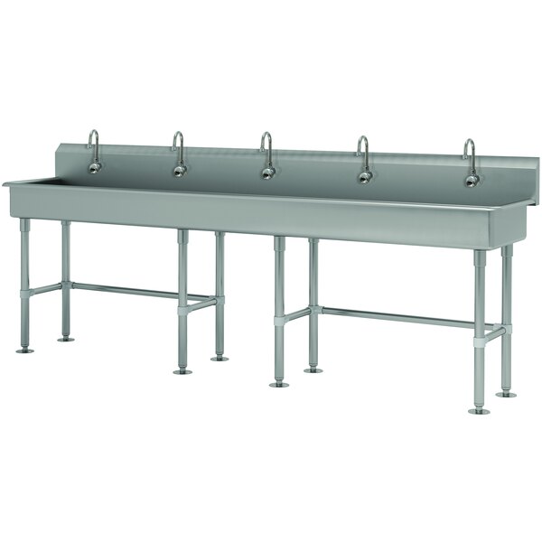 An Advance Tabco stainless steel multi-station hand sink with faucets on tubular legs.