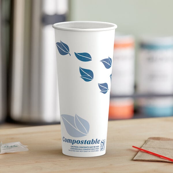 A white EcoChoice paper hot cup with a blue leaf design.