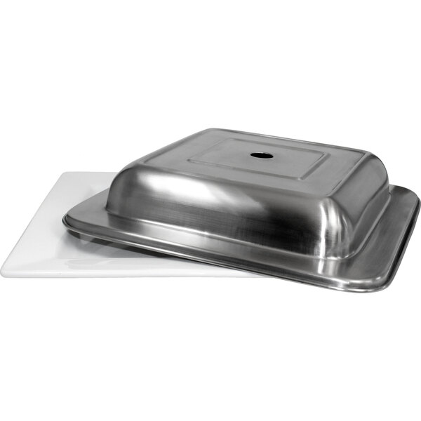 A stainless steel International Tableware square plate cover on a metal tray.