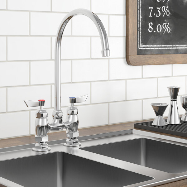 A Waterloo deck mount faucet with gooseneck spout and 4" centers on a sink with a black board above it.