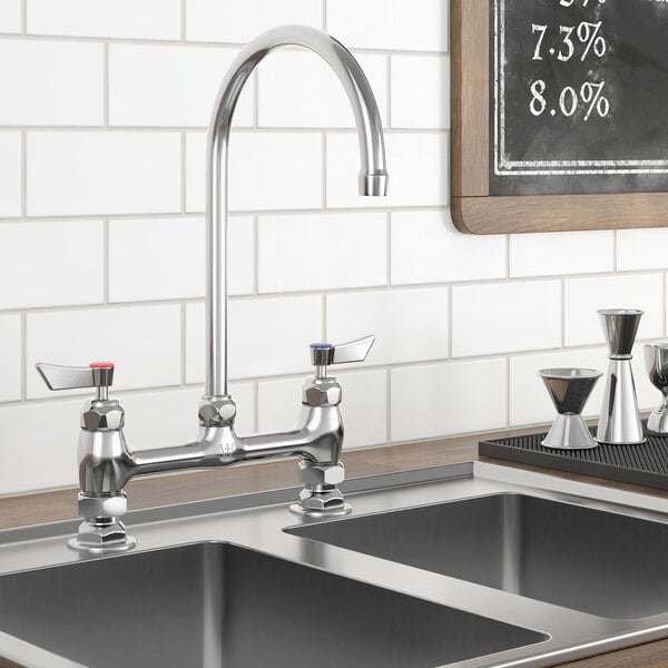 A Waterloo deck-mount faucet with gooseneck spout on a metal counter above a sink.