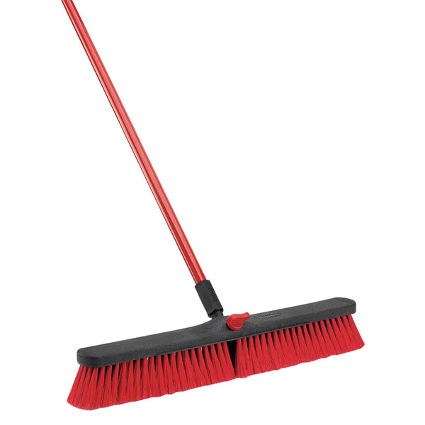 A red Libman multi-surface push broom with black bristles and handle.