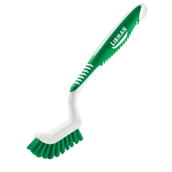 A green and white Libman Tile and Grout Brush with a handle.