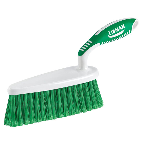 A white Libman counter brush with a green handle.