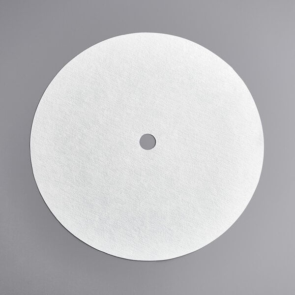 A white circular disc with a hole in the center.