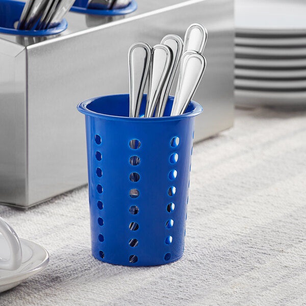 A blue plastic flatware holder with silver utensils in it.