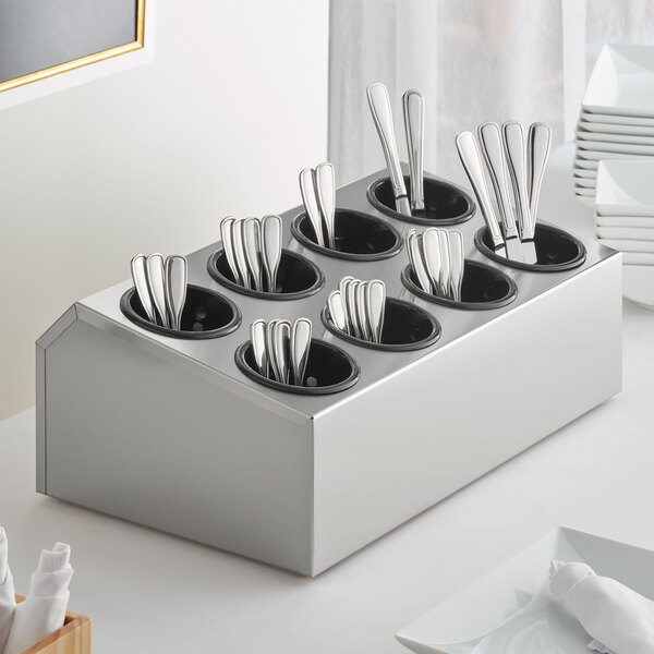 A flatware organizer with silverware in containers.