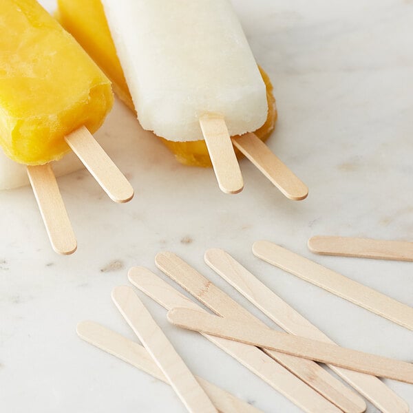 Two Choice wooden popsicle sticks with yellow and white popsicles.