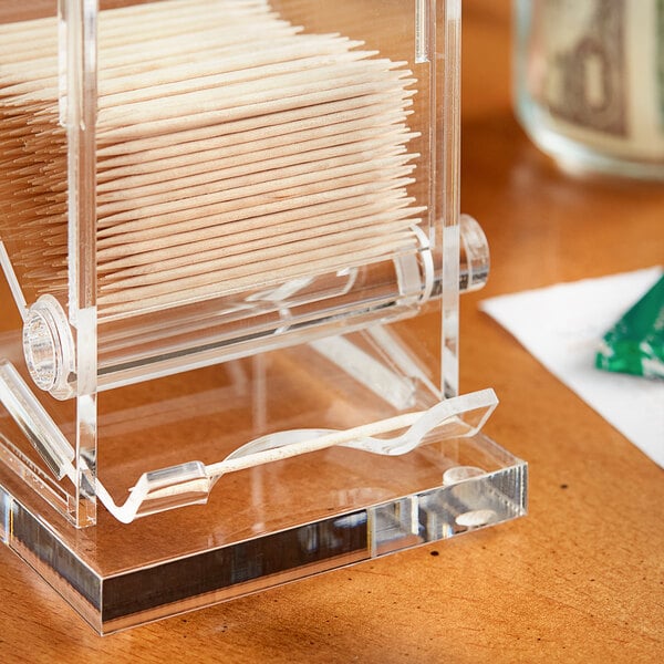 A clear plastic box with a stack of Choice unwrapped round wooden toothpicks inside.