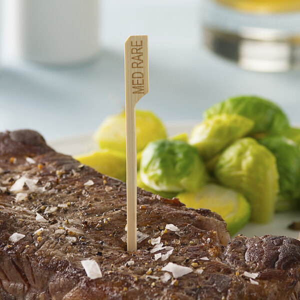 A piece of meat with a Bamboo by EcoChoice toothpick in the middle of it.