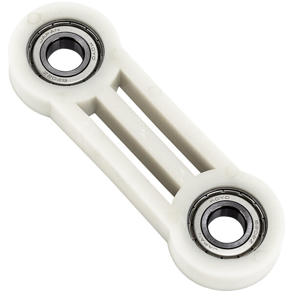 A white plastic Estella replacement bearing with two round holes.
