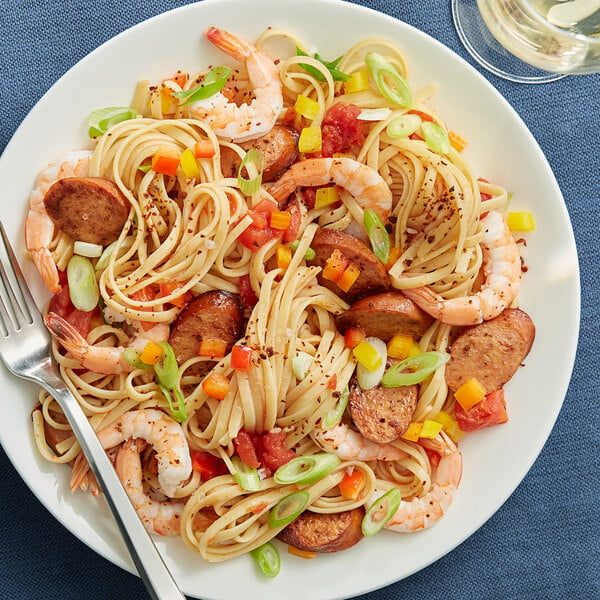 A plate of Barilla linguine pasta with shrimp and vegetables.
