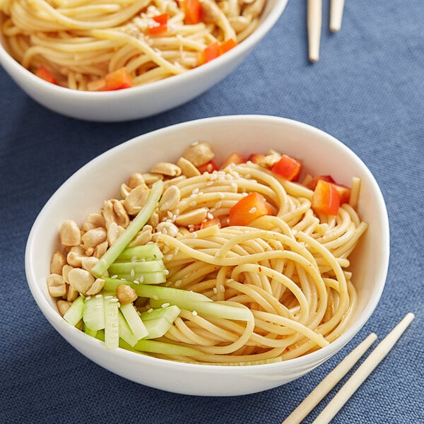 A bowl of Barilla Thick Spaghetti with vegetables.