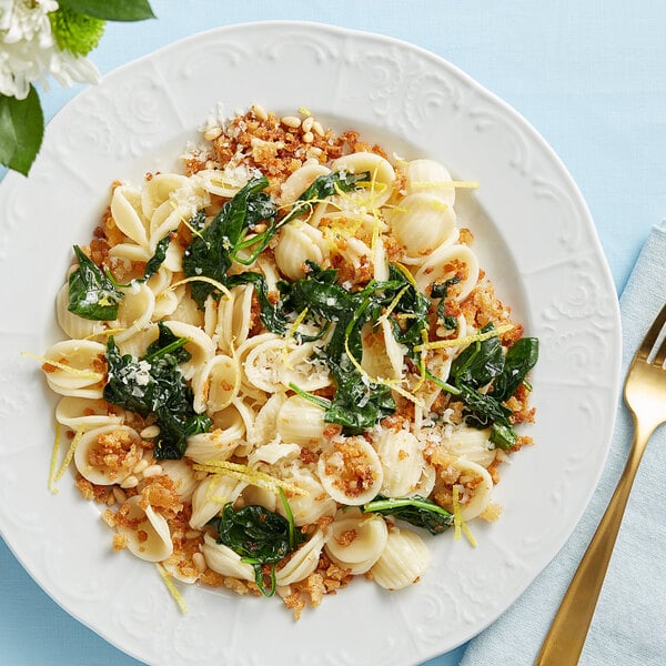 A plate of Barilla Orecchiette pasta with spinach and cheese.