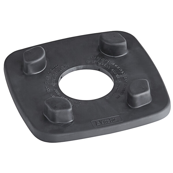 A black square Vitamix jar pad with four holes.