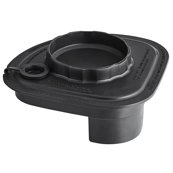 A black plastic container lid with a round hole and a tethered plug.