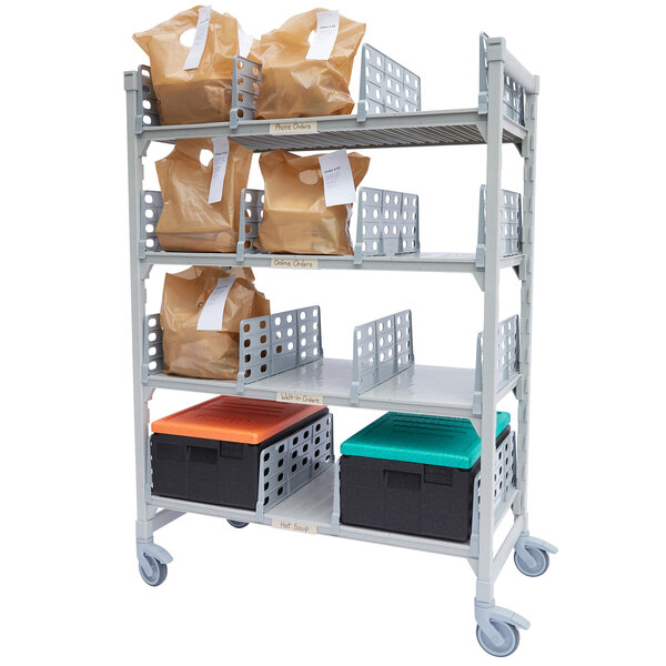 A Cambro Camshelving Premium metal shelving unit with plastic bags and containers.