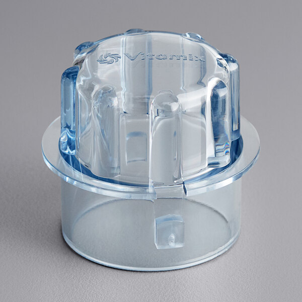 A clear plastic container with a blue lid plug.
