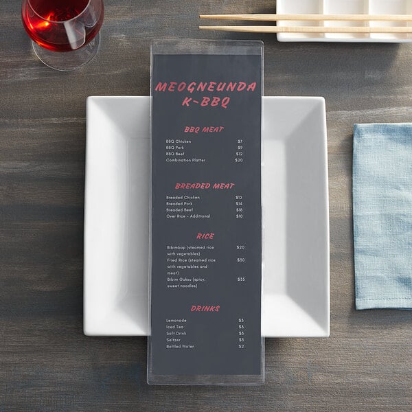 A clear menu cover with a price list on a table in an Asian cuisine restaurant.