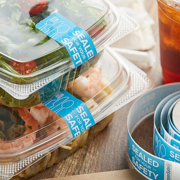 Plastic containers of food with TamperSafe blue labels on them.