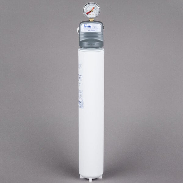 A white Manitowoc Arctic Pure water filtration system cylinder with a gauge on top.