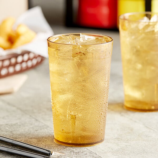 Two Choice amber plastic tumblers filled with ice tea and ice.