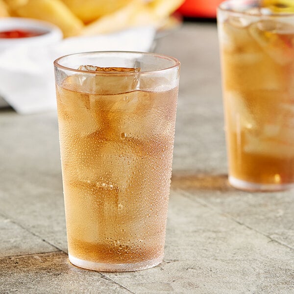 A clear Choice plastic tumbler filled with ice tea and ice cubes.