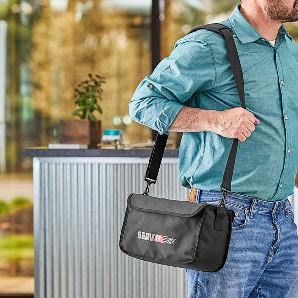 A man carrying a black ServIt delivery bag with a red logo.