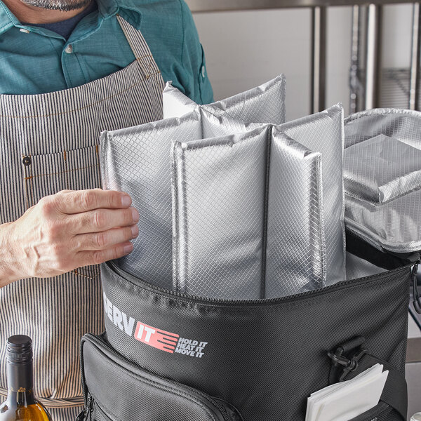A man using a ServIt Trolley Cooler Bag with silver dividers.