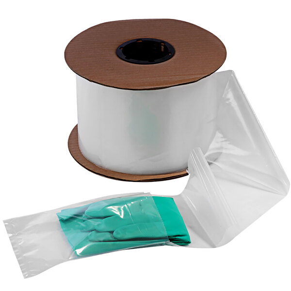 A roll of clear plastic pre-opened bags with green gloves.