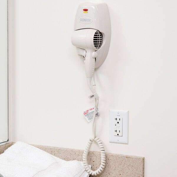 A Conair white wall mount hair dryer with a nightlight.