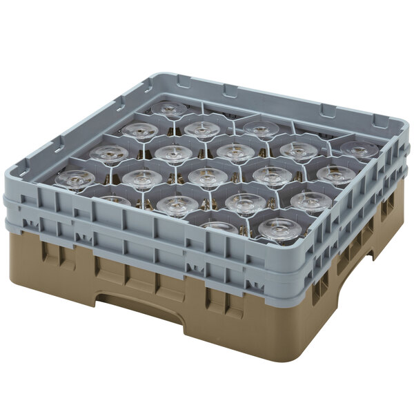 A beige plastic Cambro glass rack with clear glasses inside.