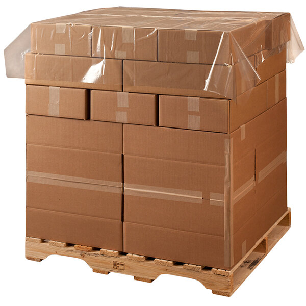A pallet with many boxes wrapped in clear plastic Lavex Polyethylene Perforated Pallet Top Sheeting.