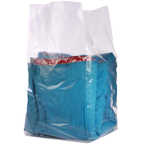 A clear plastic gusseted bag on a roll filled with blue and red clothing.