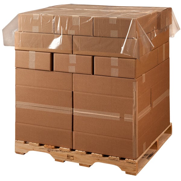 A pallet with many boxes wrapped in clear plastic with Lavex Polyethylene Perforated Pallet Top Sheeting.