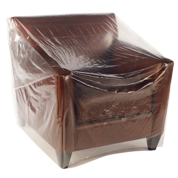A chair covered in a clear plastic Lavex bag.